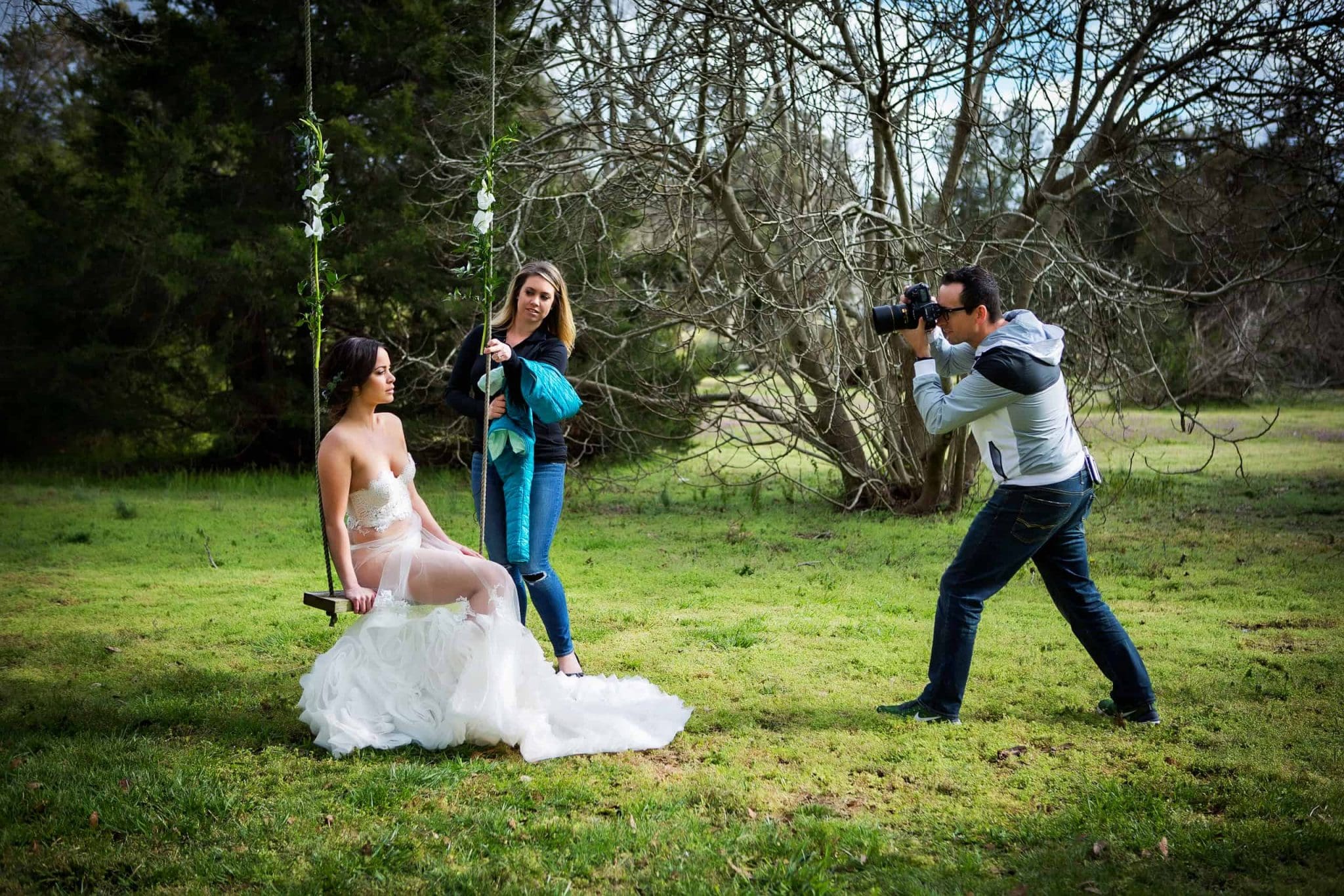 Jessica and Ross Costanza coaching a boudoir client through posing during an outdoor boudoir session